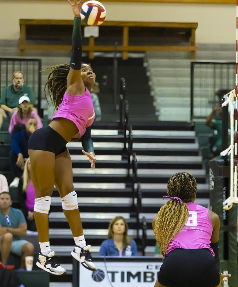 Cedar Park Timberwolves outside hitter Joy Udoye (7) leaps to return a kill shot against the Leander Lions during the second set at the District 25-5A volleyball game on Tuesday, October 17, 2023, at Cedar Park High School - Cedar Park, TX.