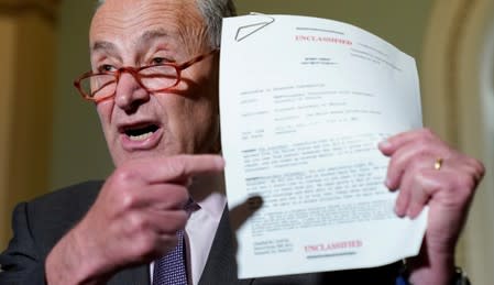 Chuck Schumer holds up a copy of the telephone conversation between Trump and Ukraine President Volodymyr Zelenskiy in Washington