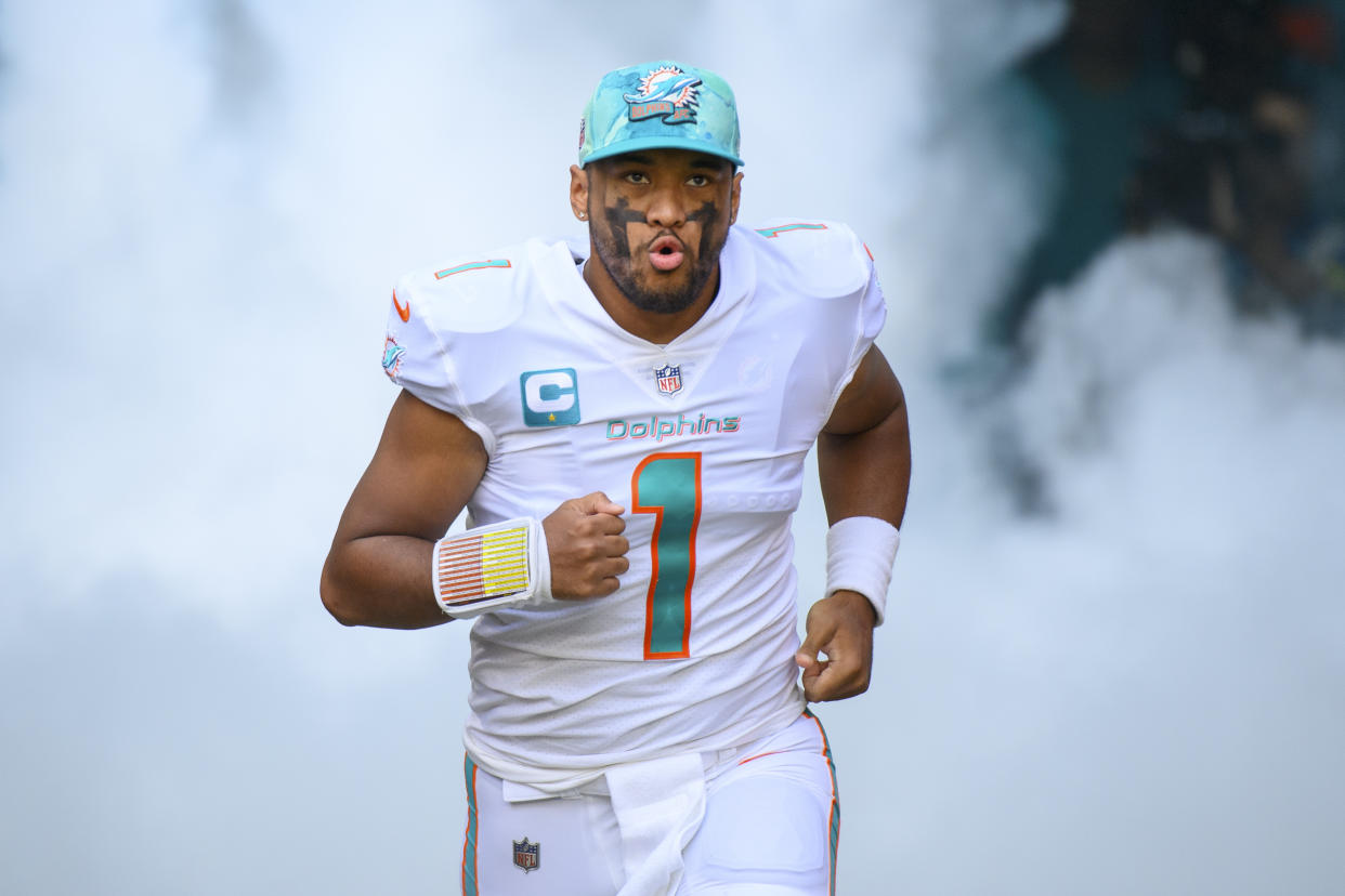 Miami Dolphins quarterback Tua Tagovailoa (1) runs onto the field as he is introduced to the fans before an NFL football game between the Houston Texans and the Miami Dolphins, Sunday, Nov. 27, 2022, in Miami Gardens, Fla. (AP Photo/Doug Murray)