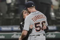 Detroit Tigers starting pitcher Spencer Turnbull (56) gets a kiss from an unidentified woman after he threw a no-hitter in a baseball game against the Seattle Mariners, Tuesday, May 18, 2021, in Seattle. The Tigers won 5-0. (AP Photo/Ted S. Warren)