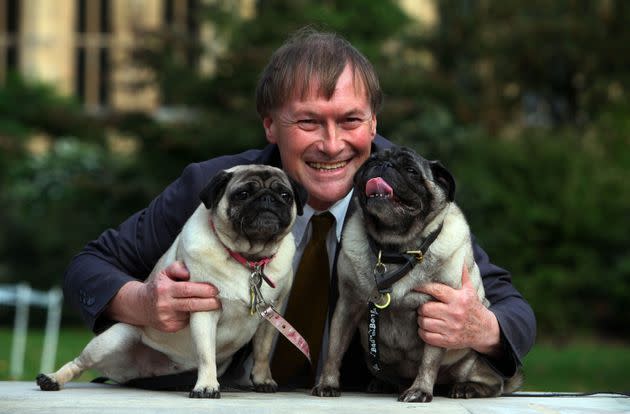 David Amess in 2013 with his pugs, Lily and Boat, at the Westminster Dog of the Year competition. (Photo: Geoff Caddick via PA Wire/PA Images)