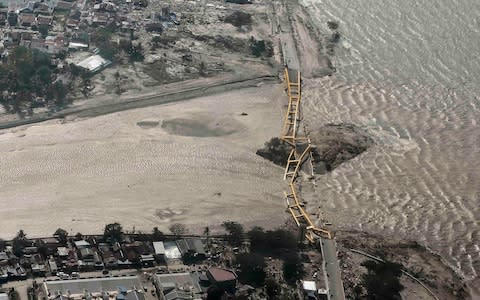 An aerial view shows bridge damaged by an earthquake and tsunami in Palu - Credit: Reuters