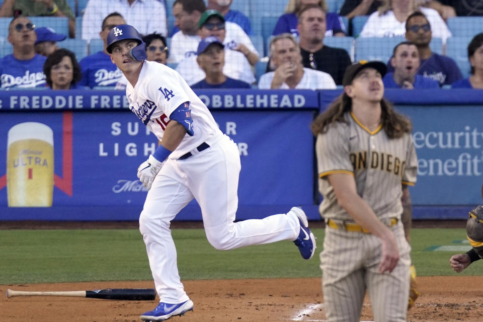 Los Angeles Dodgers' Will Smith, left, heads to first as he hits a solo home run while San Diego Padres starting pitcher Mike Clevinger watches during the second inning of a baseball game Saturday, Aug. 6, 2022, in Los Angeles. (AP Photo/Mark J. Terrill)