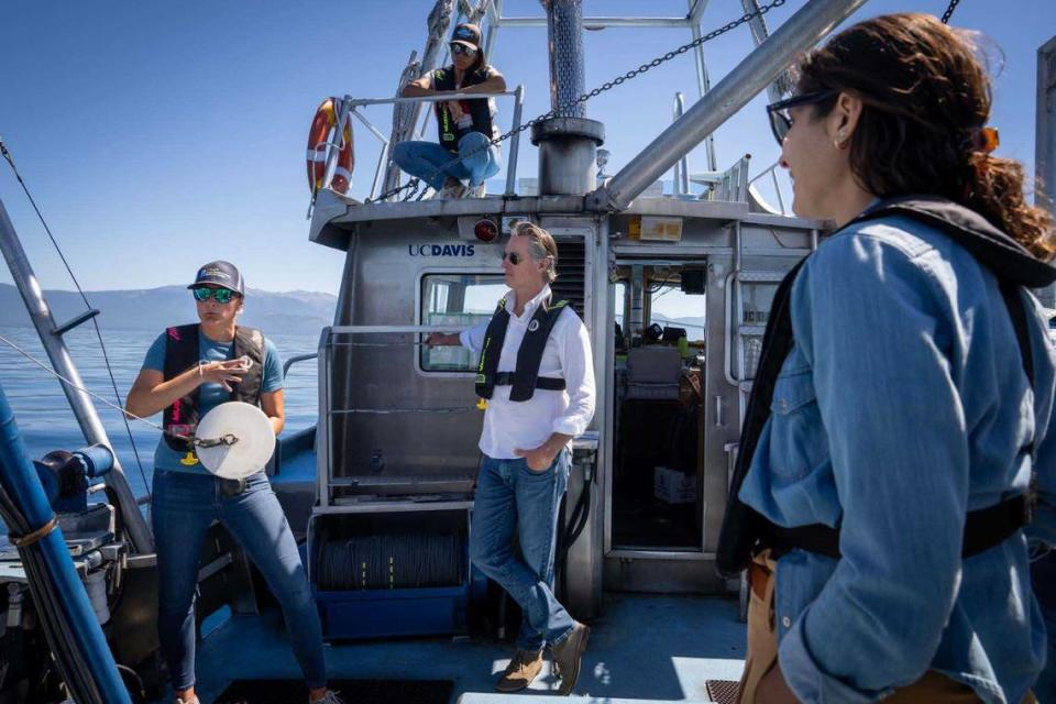 From left, Katie Senft of UC Davis, CalEPA Secretary Yana Garcia, Gov. Gavin Newsom and Lauren Sanchez, a climate advisor to Newsom, talk water clarity aboard the UC Davis TERC Research Vessel in June.