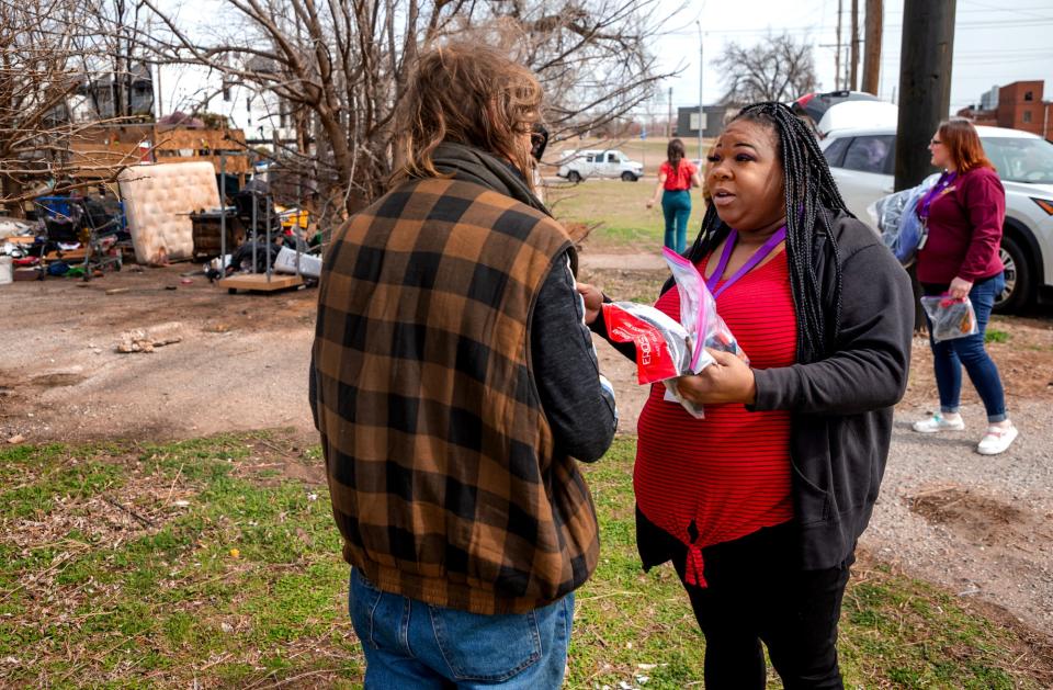 Jamille Hawkins give supplies to a homeless client on Monday, March 6, 2023, during a Mental Health Association of Oklahoma homeless outreach stop in Oklahoma City.