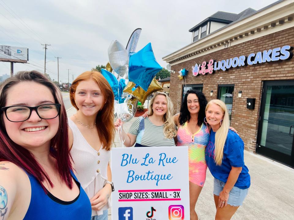 Struggling to make a go of her boutique, Ricki Craft turned to social media for help. It came when successful proprietor Laura LaRue offered her storefront. Celebrating the opening of Blu La Rue Boutique are, from left, Tessa LaRue (Laura's daughter), Haven Scott, Craft, Laura LaRue and Alicia Scott (owner of Spray Tans by Alicia, which is also in the storefront).