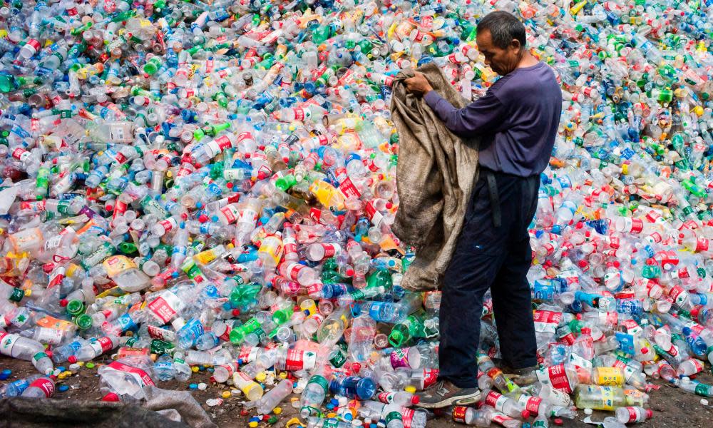 A Chinese labourer sorting out plastic bottles for recycling near Beijing. 