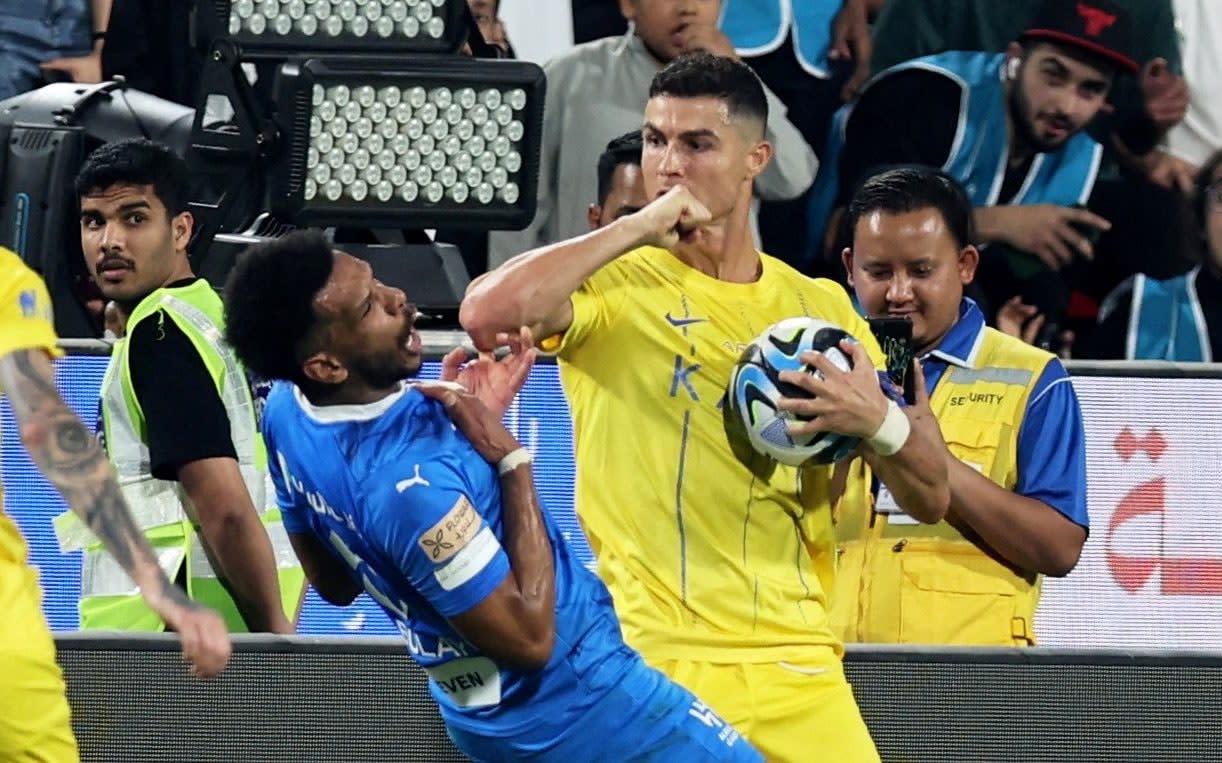 Mohammed bin Zayed Stadium, Abu Dhabi, United Arab Emirates - April 9, 2024 Al Nassr's Cristiano Ronaldo clashes with Al Hilal's Ali Al Bulayhi before being shown a red card by referee Mohammed Al Hoaish