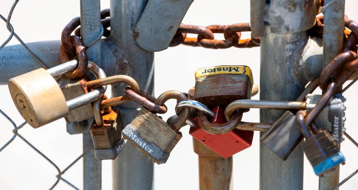 An array of locks secures the fencing around the former JFD Electronics site, a manufacturer of antennas and amplifiers, at 620 West Industry Drive in Oxford.