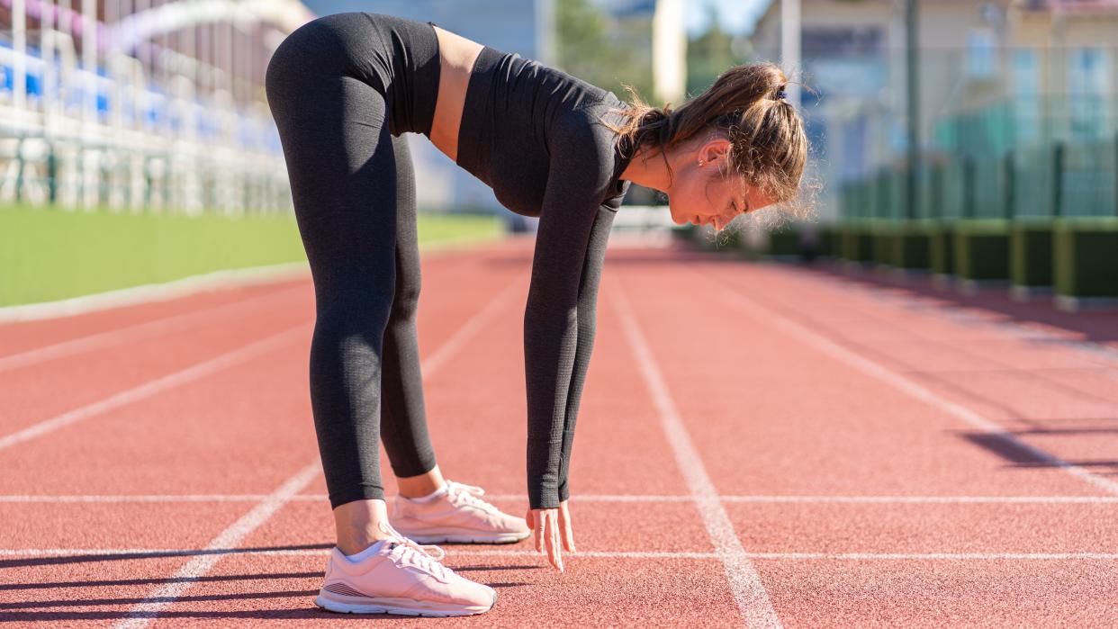  an image of a woman doing the inchworm exercise 