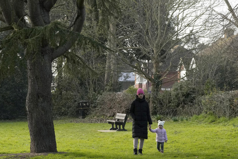 Viktoria Kovalenko and her daughter Varvara go for a walk in a village in Kent, Thursday, Feb. 9, 2023. Viktoria, 34, and her daughter Varvara are trying to settle in Britain after fleeing the war in Ukraine, where she lost her husband and 12-year-old daughter during a Russian military attack. The family have found housing through a charity, but they long to return to their own home in Ukraine. (AP Photo/Frank Augstein)