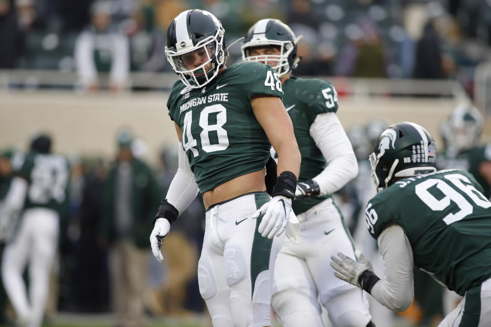 Michigan State's Kenny Willekes (48), Jack Saylor (54) and Jacub Panasiuk (96) warm up before an NCAA college football game against Maryland, Saturday, Nov. 30, 2019, in East Lansing, Mich. (AP Photo/Al Goldis)