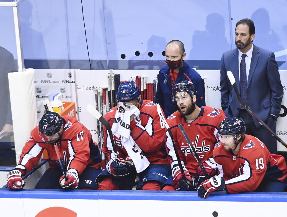 Washington Capitals captain Alex Ovechkin, second left, and teammates Ilya Kovalchuk (17) Tom Wilson (43) Nicklas Backstrom (19) watch the closing moments of the third period against the New York Islanders in an NHL Stanley Cup playoff hockey game in Toronto on Thursday, Aug. 20, 2020. (Nathan Denette/The Canadian Press via AP)