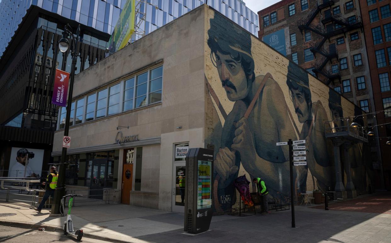 One Man Army, by Aryz, depicts four identical working-class figures on an exterior wall of 1431 Farmer St. in downtown Detroit, Thursday, April 18, 2024.