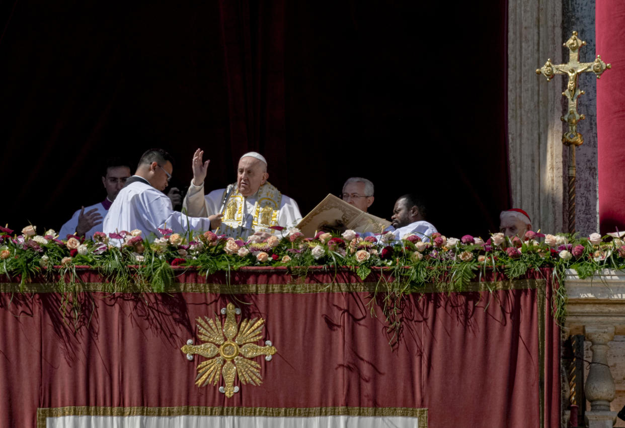 Pope Francis bestows the plenary 'Urbi et Orbi' (to the city and to the world) blessing from the central lodge of the St. Peter's Basilica at The Vatican at the end of the Easter Sunday mass, Sunday, April 9, 2023. (AP Photo/Alessandra Tarantino)