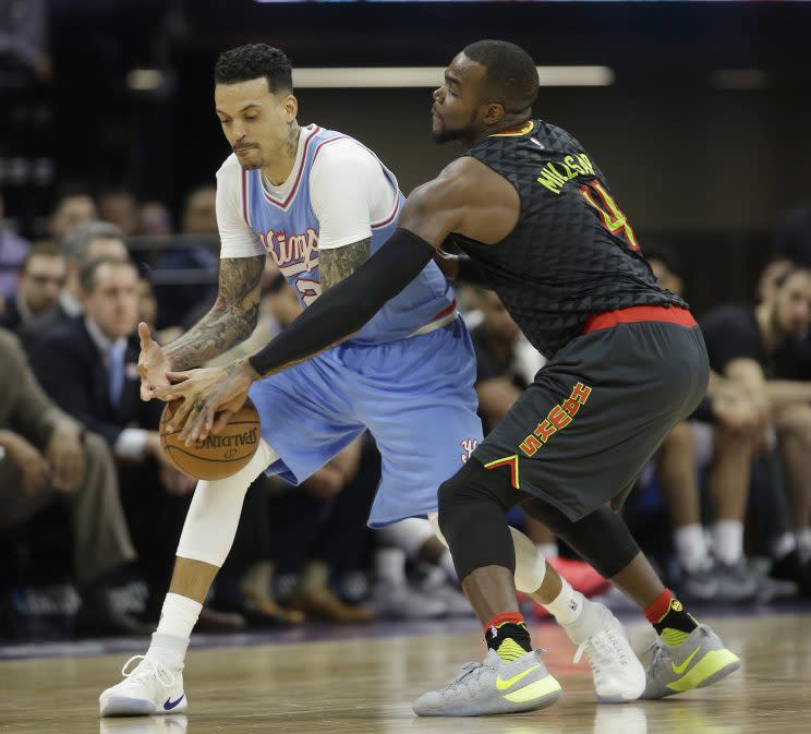 Paul Millsap tries to give Matt Barnes a big hug. (AP)