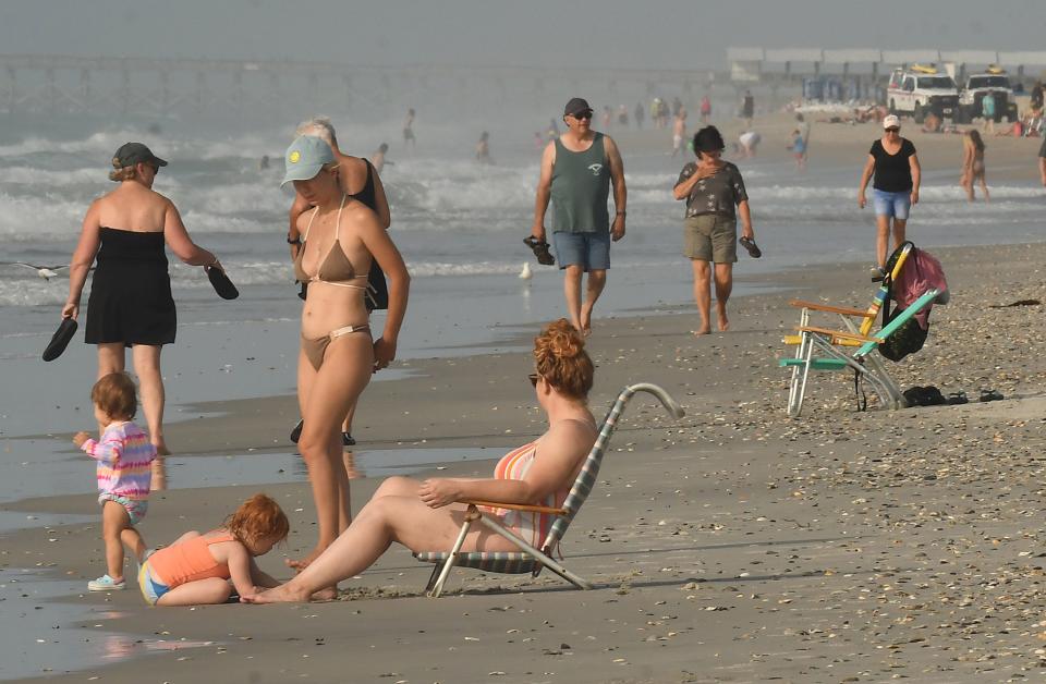 People enjoy a day at the beach June 14, 2022 at Wrightsville Beach, N.C.