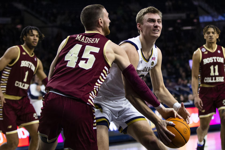 Boston College's Mason Madsen (45) fouls Notre Dame's Dane Goodwin (23) during the second half of an NCAA college basketball game Saturday, Jan. 21, 2023 in South Bend, Ind. (AP Photo/Michael Caterina)