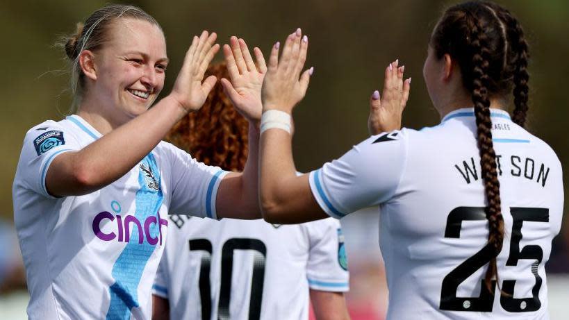 Elise Hughes celebrates a goal for Crystal Palace with Lucy Watson