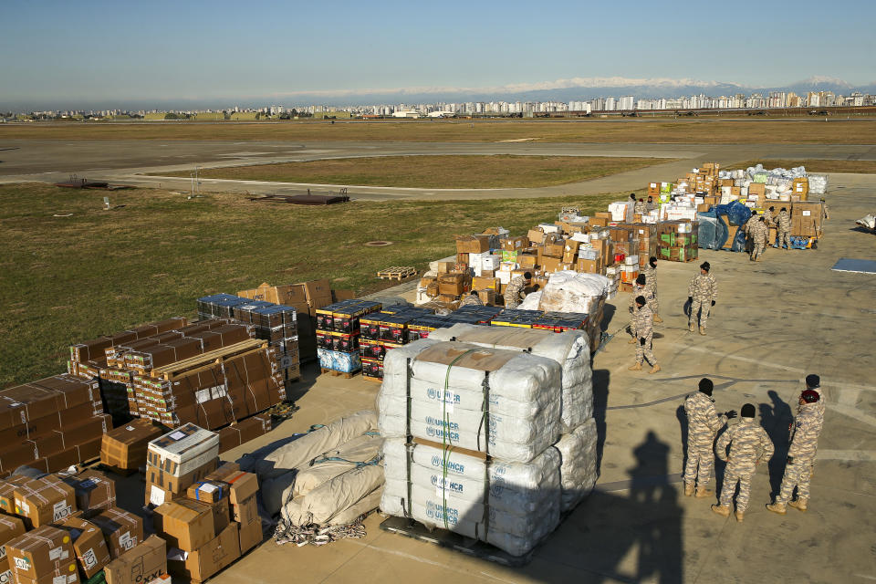 Turkish soldiers prepare aid supplies for the survivors of devastating earthquake at Incirlik military airbase in Adana, southern Turkey, Tuesday, Feb. 14, 2023. Thousands left homeless by a massive earthquake that struck Turkey and Syria a week ago packed into crowded tents or lined up in the streets for hot meals as the desperate search for survivors entered what was likely its last hours. (AP Photo/Emrah Gurel)
