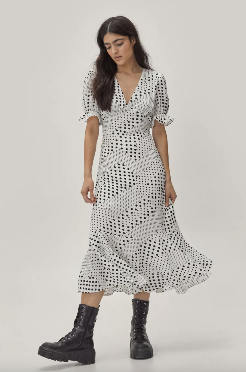 brunette model in black combat boots and black white Mixed Spot Print Fitted Midi Dress (Photo via Nasty Gal)