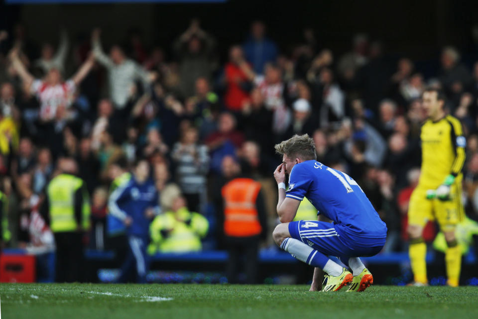 Chelsea's Andre Schurrle remains on the pitch following the English Premier League soccer match against Sunderland at the Stamford Bridge ground in London, Saturday, April 19, 2014. Sunderland won the match 2-1. (AP Photo/Lefteris Pitarakis)