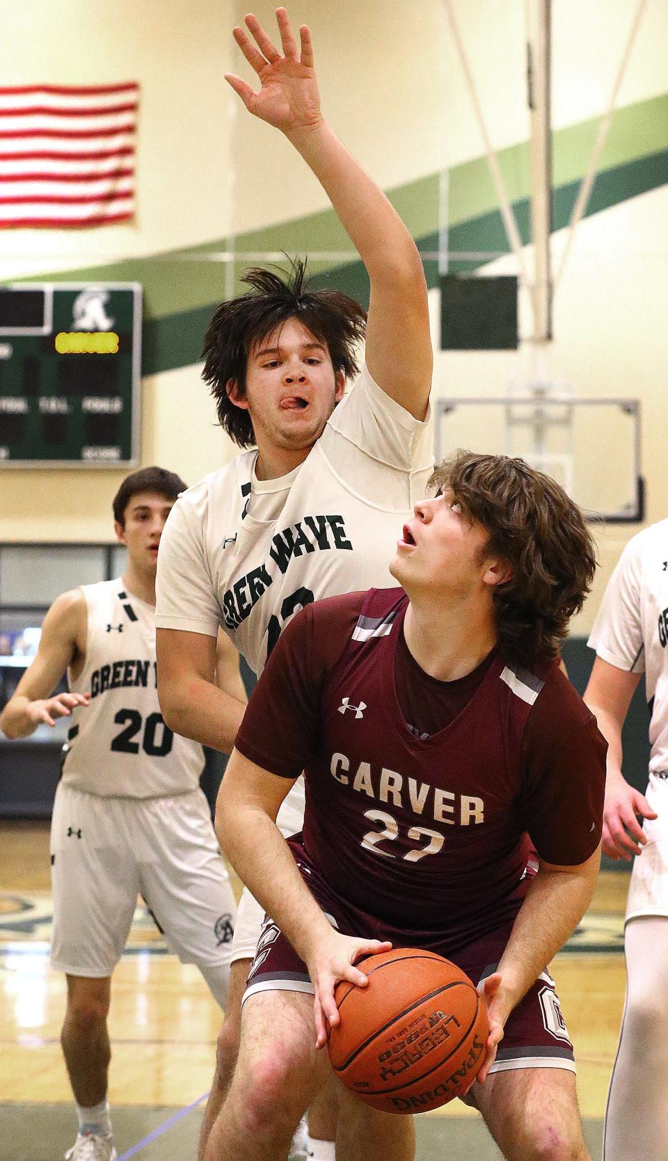 Crusader James Callahan looks for an opening for a lay up under guard Connor Pease

The Abington Green Wave hosted the Carver Crusaders in boys basketball on Friday Dec. 22, 2023