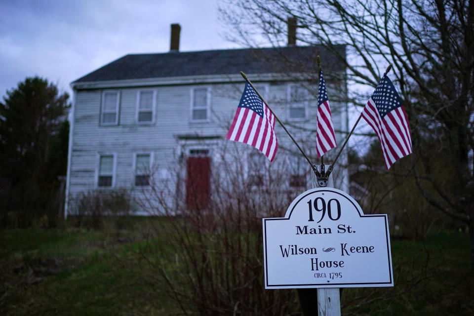 American flags are displayed outside the historic Wilson Keene House, Thursday, April 27, 2023, in Columbia Falls, Maine. (AP Photo/Robert F. Bukaty)