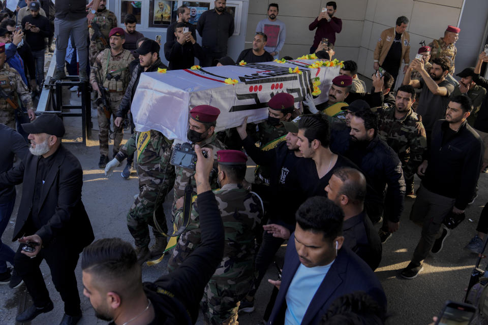 Members of an Iraqi Shiite militant group carry the coffin during the funeral of a fighter with the Kataib Hezbollah, who was killed in a U.S. airstrike, in Baghdad, Iraq, Thursday, Jan. 25, 2024. (AP Photo/Hadi Mizban)