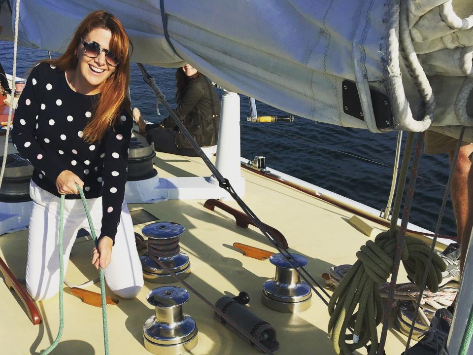 andrea rigging up a rope on a sailboat in rhode island