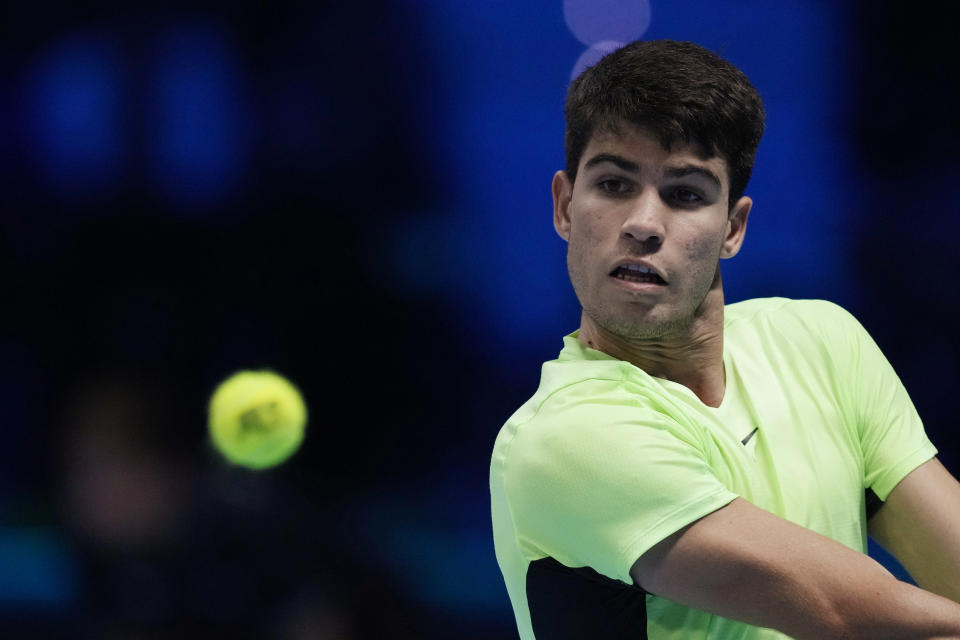 Spain's Carlos Alcaraz returns the ball to Germany's Alexander Zverev during their singles tennis match of the ATP World Tour Finals at the Pala Alpitour, in Turin, Italy, Monday, Nov. 13, 2023. (AP Photo/Antonio Calanni)