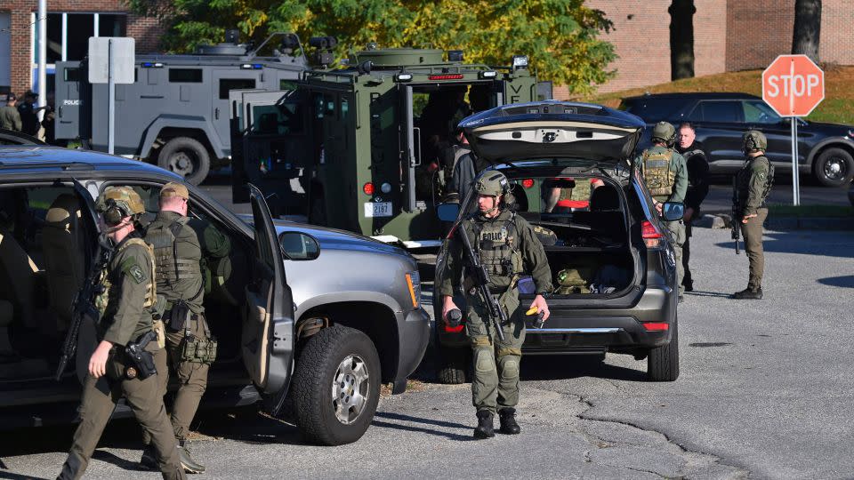 Law enforcement prepare for a search for a gunman who killed 18 people two days ago, in Lewiston, Maine, on Friday. - Angela Weiss/AFP/Getty Images