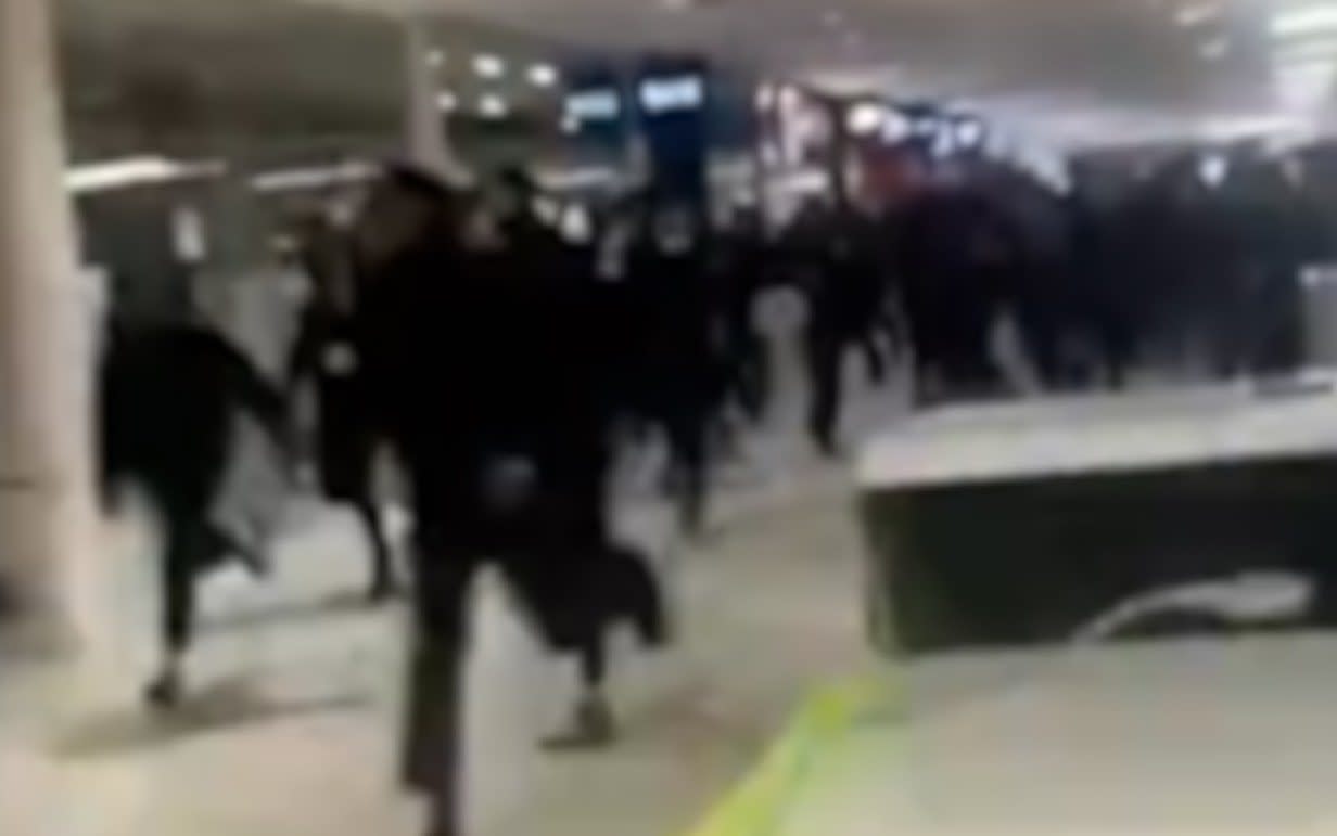 Children running through shopping centre