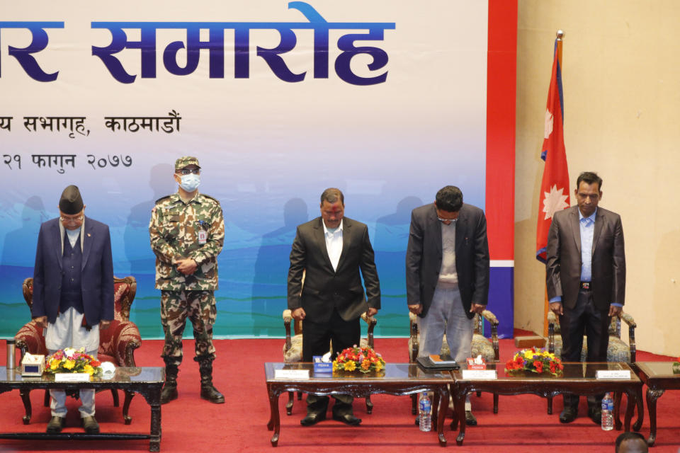 Nepalese Prime Minister Khadga Prassad Oli, left, and leader of Nepal Communist Party group Netra Bikram Chand, third right, along with others pay respects to martyrs during a signing of peace agreement in Kathmandu, Nepal, Friday, March 5, 2021. Chand, who is better known by his guerrilla name Biplav, emerged out of hiding on Friday after the government lifted a ban on his group so it could take part in the public signing of the peace agreement. This group had split from the Maoist Communist party, which fought government troops between 1996 and 2006, when it gave up its armed revolt, agreed to U.N.-monitored peace talks and joined mainstream politics. (AP Photo/Niranjan Shrestha)