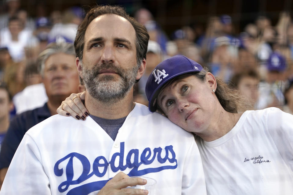 Fans watch during a ceremony to honor the memory of Los Angeles Dodgers announcer Vin Scully prior to a baseball game between the Dodgers and the San Diego Padres Friday, Aug. 5, 2022, in Los Angeles. Scully, the Hall of Fame broadcaster, whose dulcet tones provided the soundtrack of summer while entertaining and informing Dodgers fans in Brooklyn and Los Angeles for 67 years, died Tuesday night. (AP Photo/Mark J. Terrill)