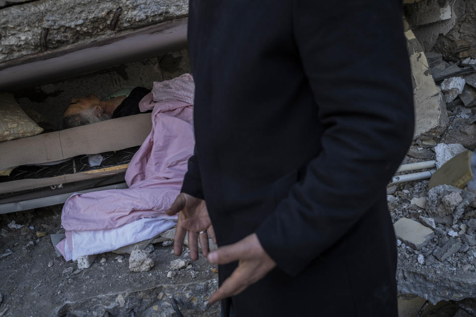CORRECTS SPELLING OF FAMILY NAME - Zafer Mahmut Boncuk, 60, screams angrily next to the body of his dead mother, Ozcan Bencuk, in Antakya, southeastern Turkey, Saturday, February 11, 2023. Ozcan Boncuk, 75, was trapped during an earthquake that struck a border region of Turkey and Syria and died on Tuesday, a day later. (AP Photo/Bernat Armangue)
