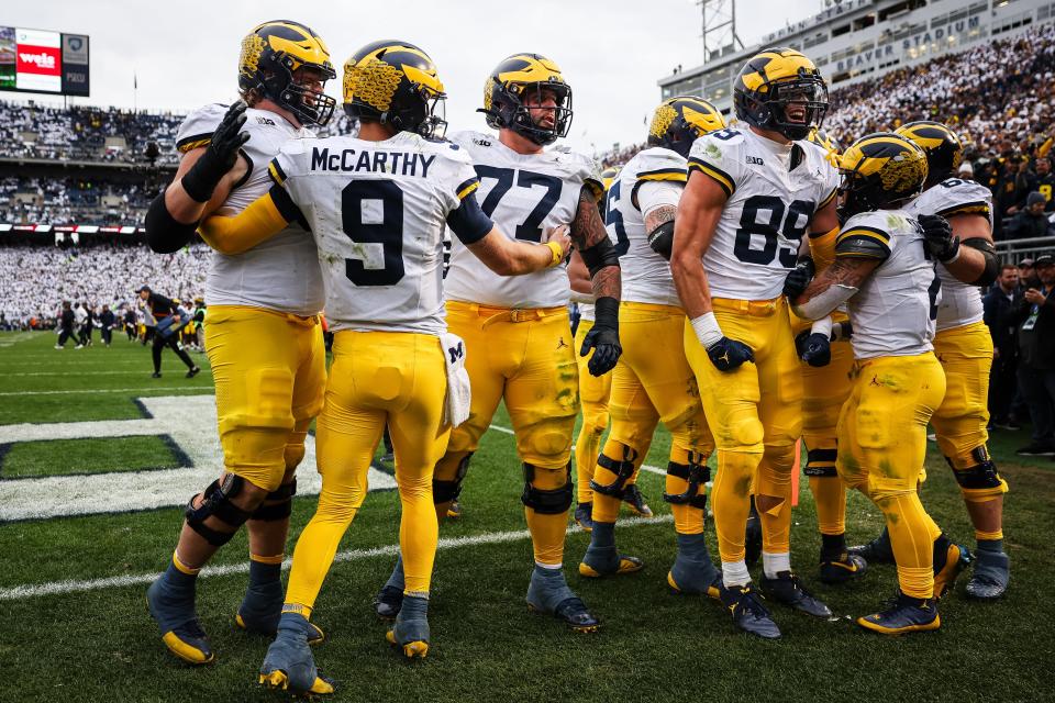 Blake Corum of the Michigan Wolverines celebrates with teammates after scoring a touchdown during the second half against the Penn State Nittany Lions at Beaver Stadium on Nov. 11, 2023 in State College, Pennsylvania.