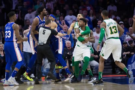 Mar 20, 2019; Philadelphia, PA, USA; Philadelphia 76ers center Joel Embiid (21) and Boston Celtics guard Marcus Smart (36) are separated by teammates after an altercation during the third quarter at Wells Fargo Center. Mandatory Credit: Bill Streicher-USA TODAY Sports