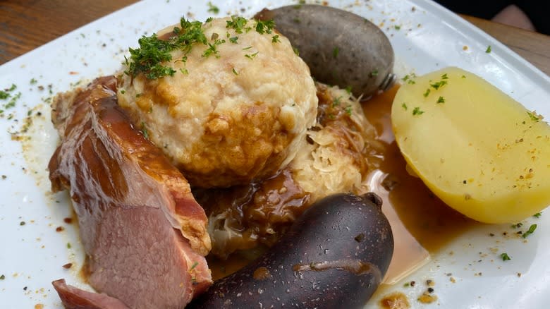 liver dumplings with sauerkraut and black pudding