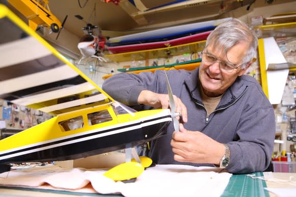 A man building a model airplane.