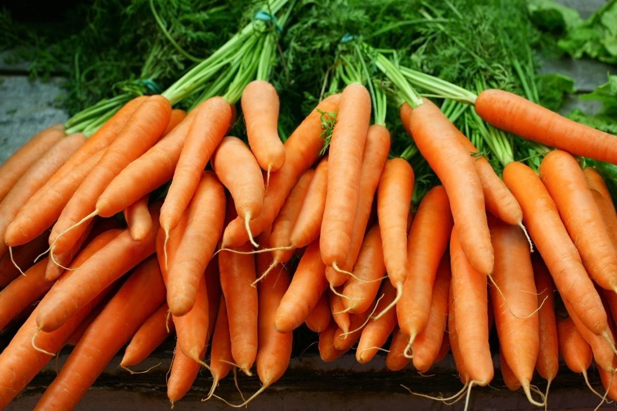 Bunches of organic carrots on a farmer market.