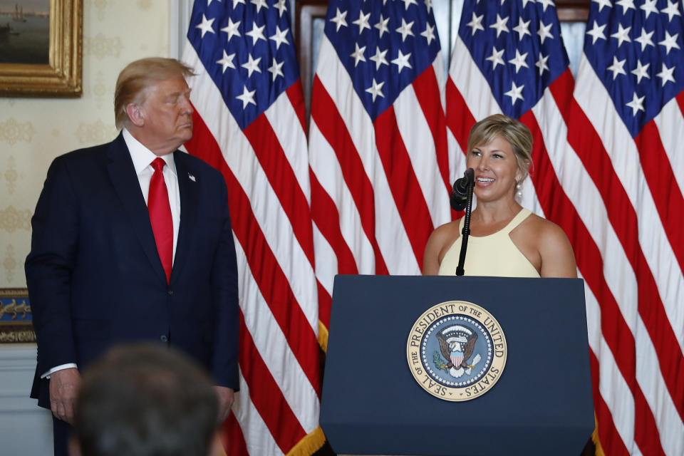 President Donald Trump listens as Catharine Ryun speaks during an event to present the Presidential Medal of Freedom to her father Jim Ryun, in the Blue Room of the White House, Friday, July 24, 2020, in Washington. (AP Photo/Alex Brandon)