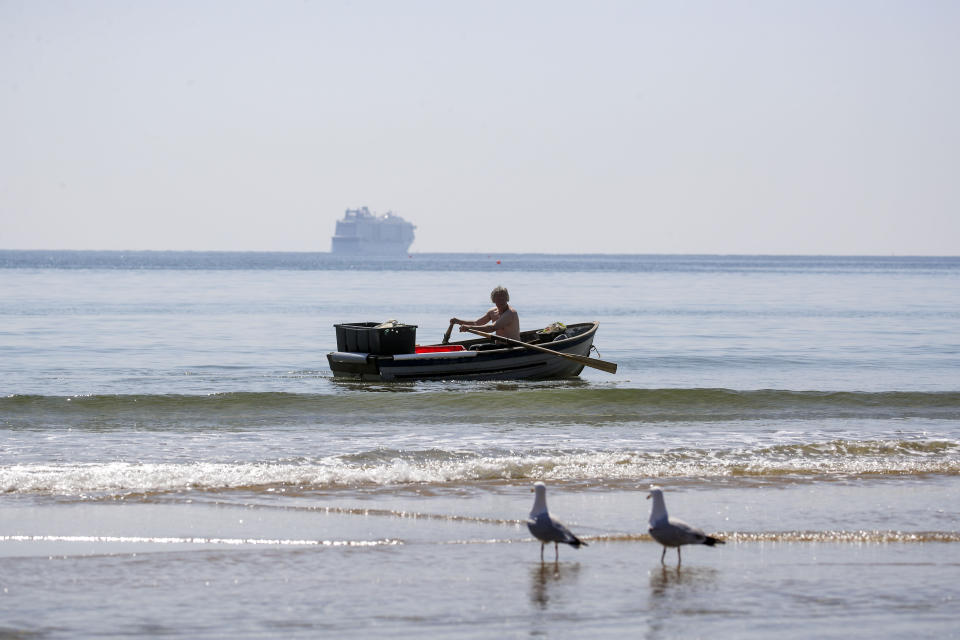 <p>A man rows a boat on the Solent in Bournemouth, Dorset. Picture date: Monday April 19, 2021.</p>
