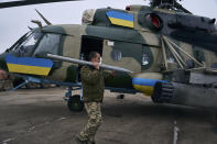 A soldier loads the weapon in a helicopter at a Ukrainian military air base close to the frontline in the Kherson region, Ukraine, Sunday, Jan. 8, 2023. (AP Photo/LIBKOS)