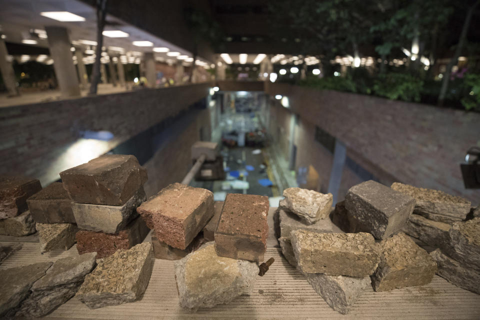 In this Thursday, Nov. 21, 2019, photo, stones used by protesters are left at the Hong Kong Polytechnic University in Hong Kong. Most of the protesters who took over the university have left following clashes with police, but an unknown number have remained inside, hoping somehow to avoid arrest. (AP Photo/Vincent Thian)