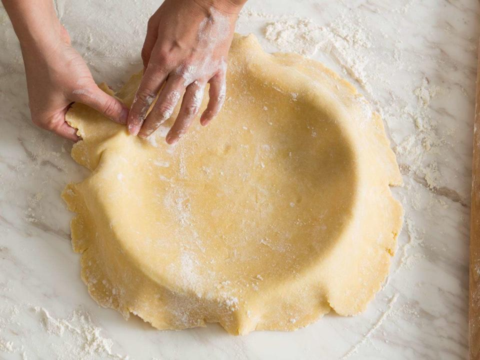 <p>Gently lift and fit the dough into the pie plate, getting down into the corners.</p>
