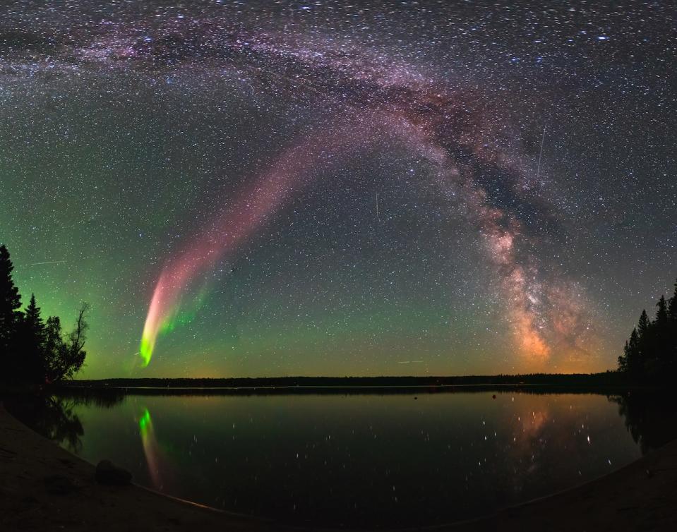 The majestic aurora-like phenomenon "Steve," now given the official acronym STEVE, shines with the Milky Way over Childs Lake, Manitoba in Canada. <cite>Krista Trinder</cite>