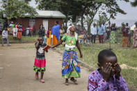 Relatives grieve as they wait to collect the bodies of villagers who were killed by suspected rebels as they retreated from Saturday's attack on the Lhubiriha Secondary School, outside the mortuary of the hospital in Bwera, Uganda Sunday, June 18, 2023. Ugandan authorities have recovered the bodies of 41 people including 38 students who were burned, shot or hacked to death after suspected rebels attacked the school in Mpondwe near the border with Congo, according to the local mayor. (AP Photo/Hajarah Nalwadda)