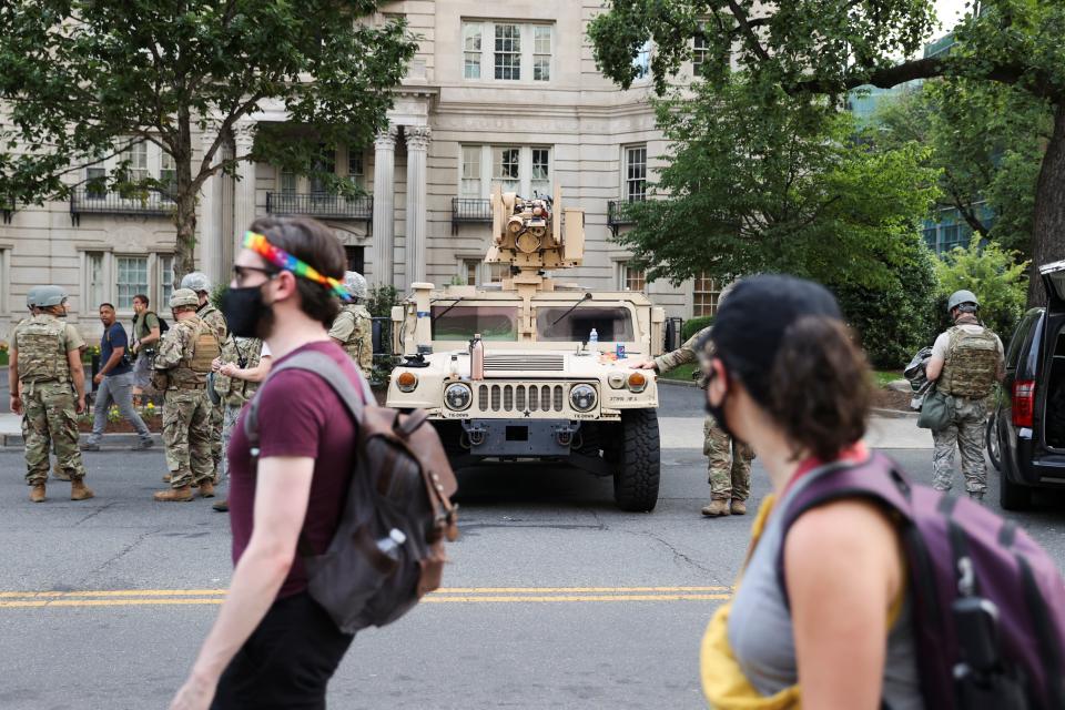 People walk past an armored vehicle during a protest against the death in Minneapolis police custody of George Floyd, near the White House in Washington, U.S., June 3, 2020. REUTERS/Jonathan Ernst