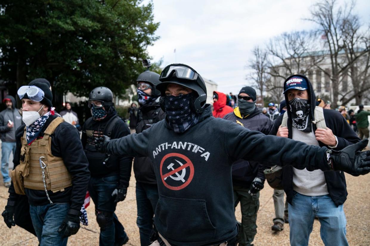 <span class="caption">Protesters who claimed to be members of the far-right Proud Boys gather with other Trump supporters outside the U.S. Capitol on Jan. 6, 2021.</span> <span class="attribution"><a class="link " href="https://www.gettyimages.com/detail/news-photo/protester-who-claim-to-be-a-members-of-the-proud-boys-news-photo/1230457937?adppopup=true" rel="nofollow noopener" target="_blank" data-ylk="slk:Alex Edelman/AFP via Getty Images;elm:context_link;itc:0;sec:content-canvas">Alex Edelman/AFP via Getty Images</a></span>